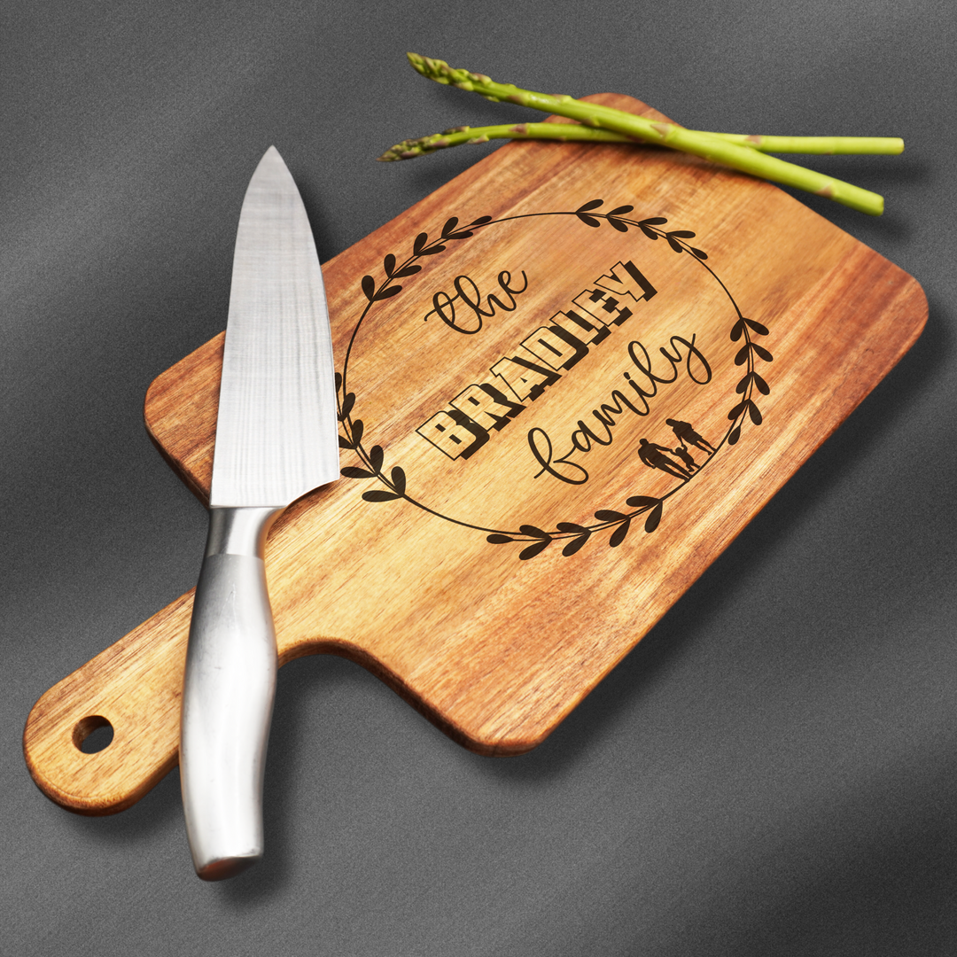 Medium sized Cutting board with a handle that is laser engraved with a family name.