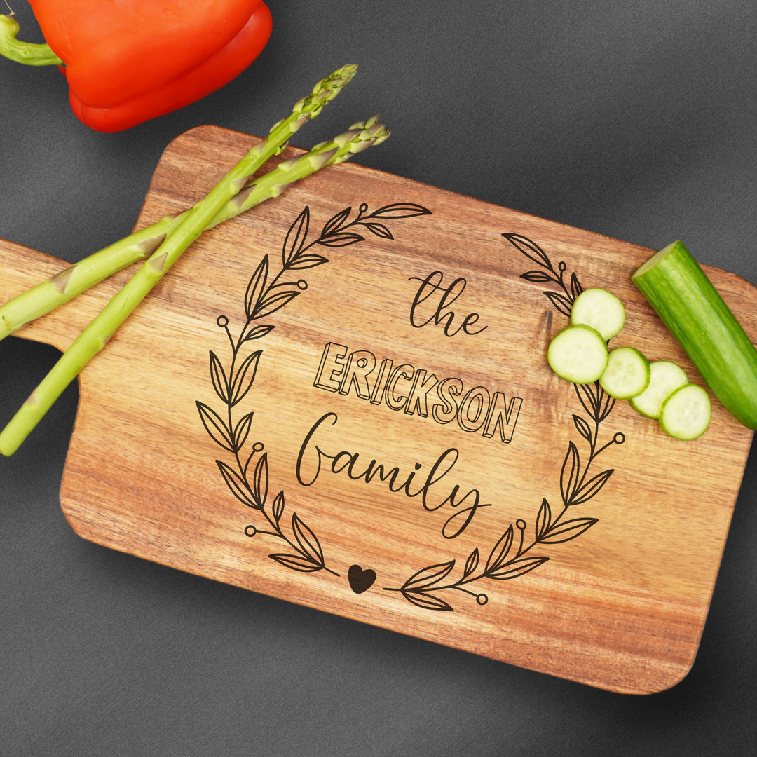 Cutting board with a handle that is laser engraved with a family name.