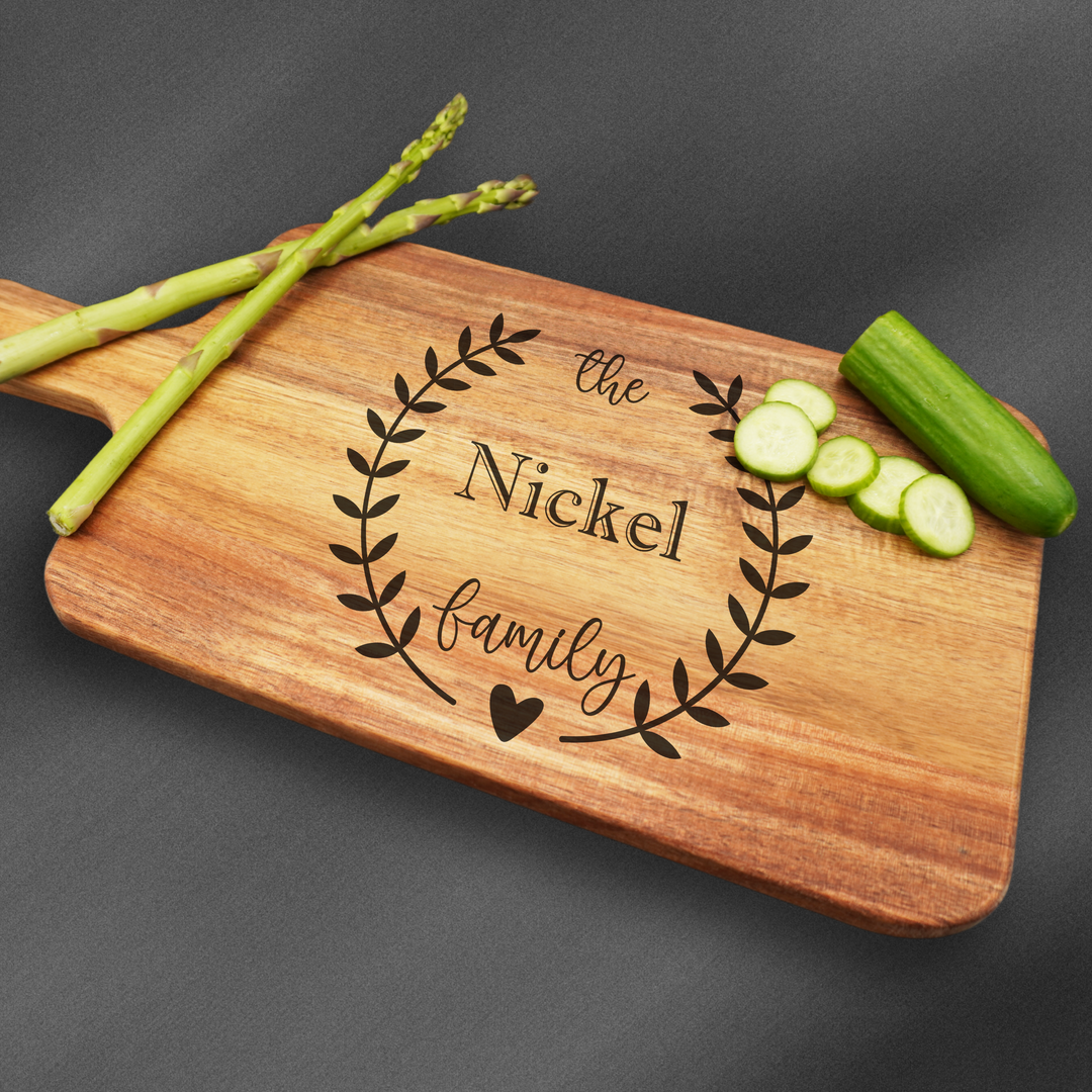 Cutting board with a handle that is laser engraved with a family name.