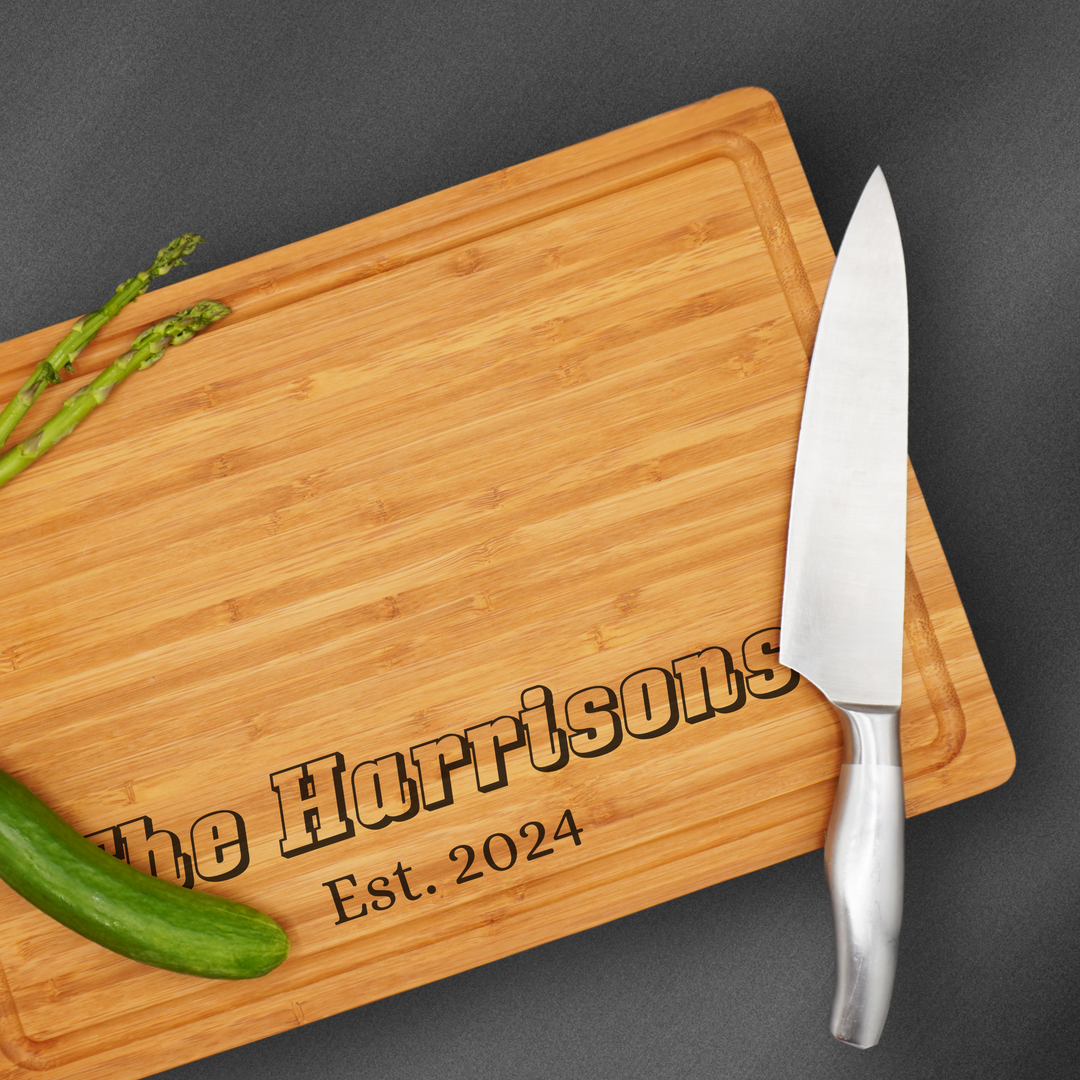 Large personalized cutting board engraved at the base with a family name