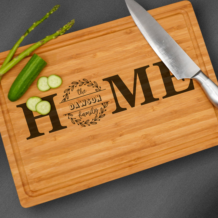 Personalized wooden cutting board engraved with a family name.