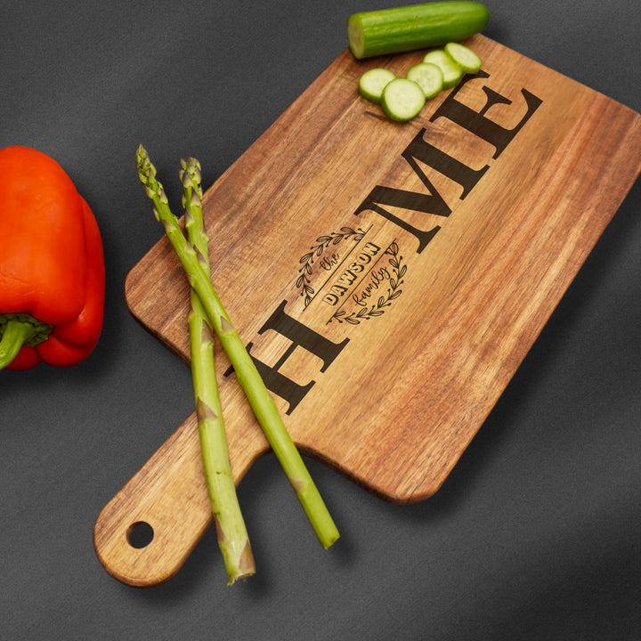 Personalized wooden cutting board engraved with a name.