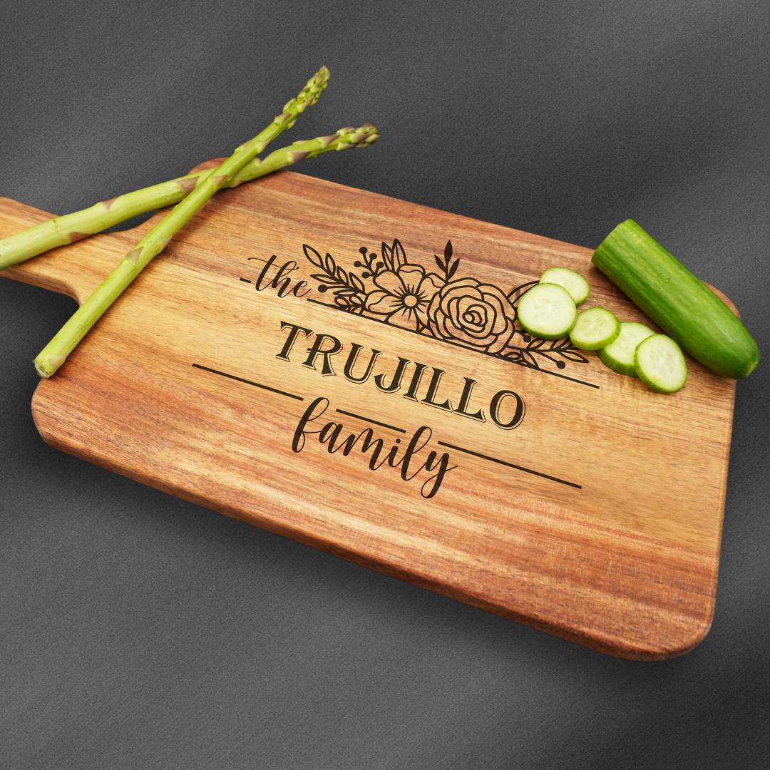 Personalized cutting board with handle engraved in the center. Perfect for housewarming gifts.